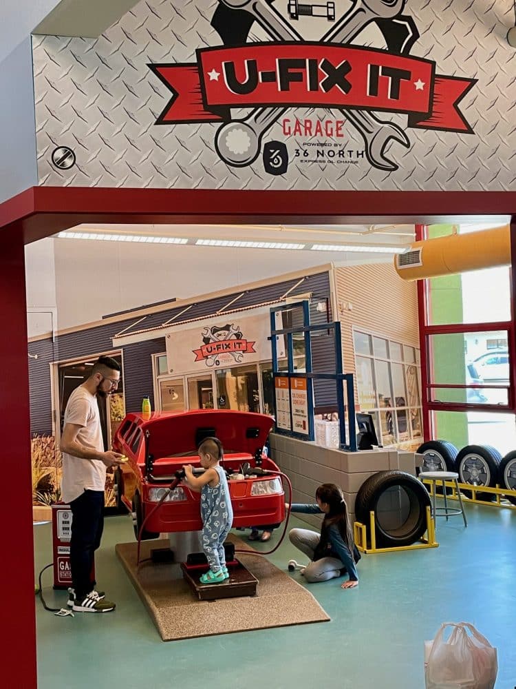 kids "fixing" a car - things to do in visalia