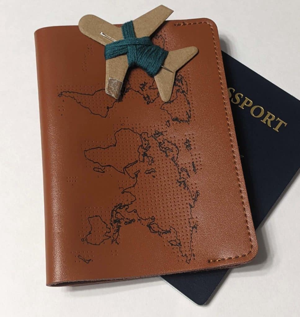 A leather passport cover that allows travelers to mark where they've visited. Father's Day gift ideas 2022