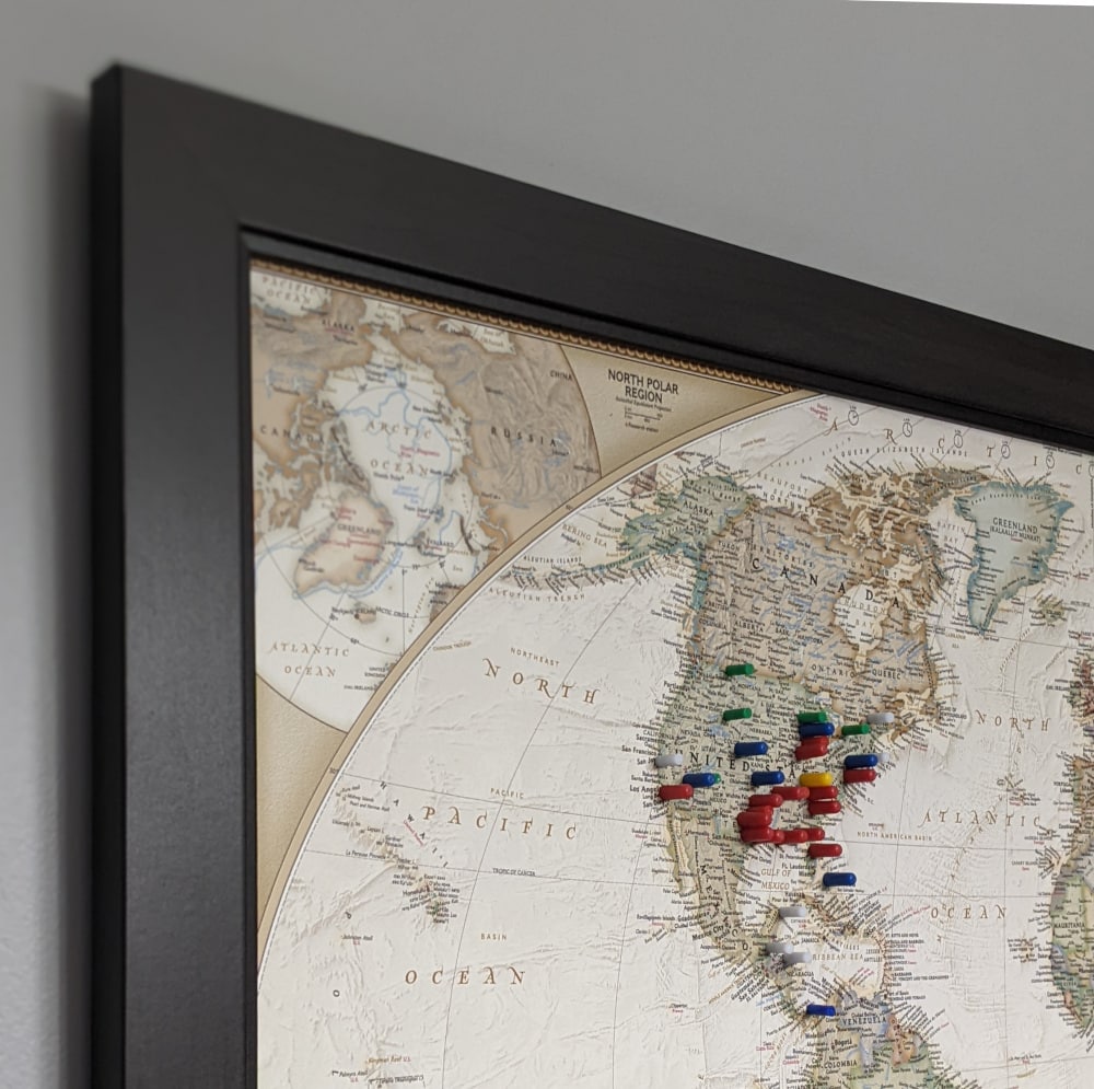 A framed map of the world with magnetic pins to mark travel plans. Father's Day gift ideas 2022