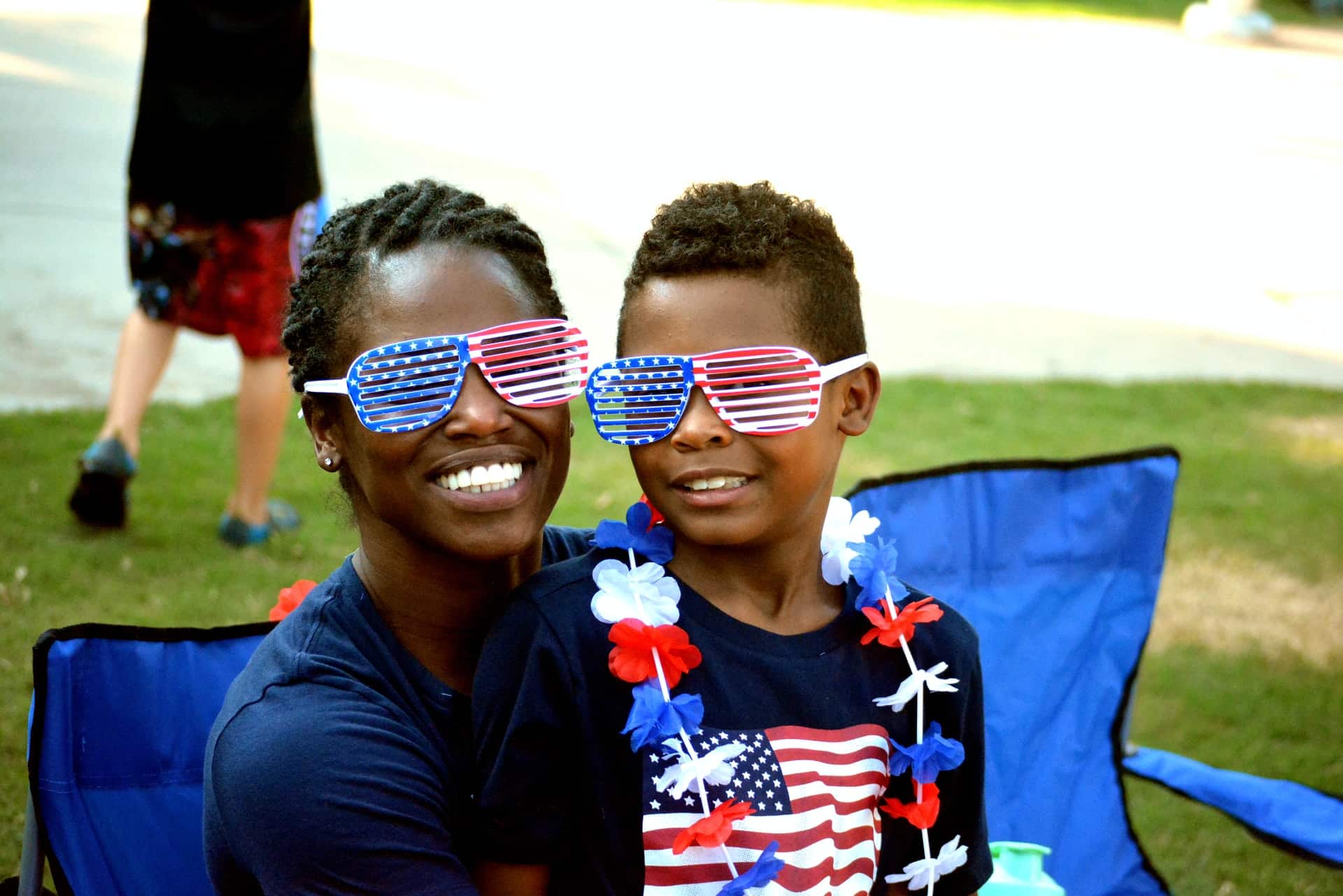 mother and son siting and wearing red white blue glasses for parade - 4th of july in washington dc with kids