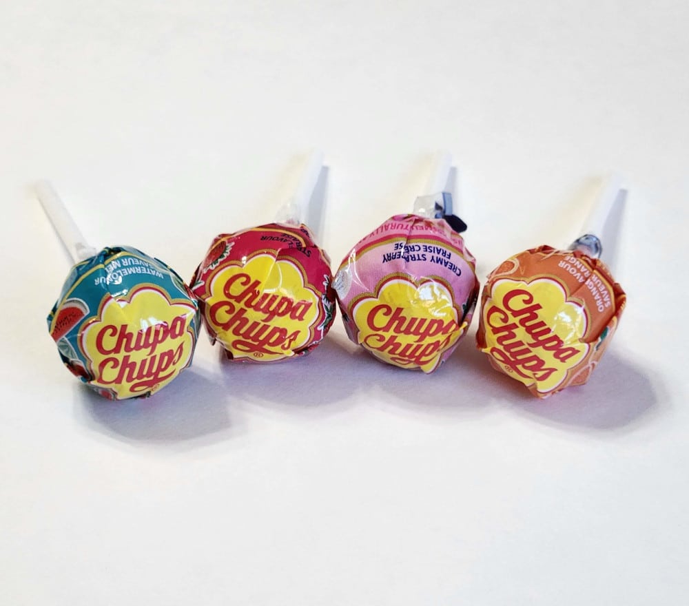 A row of four Chupa Chups lollipops, candy from Spain