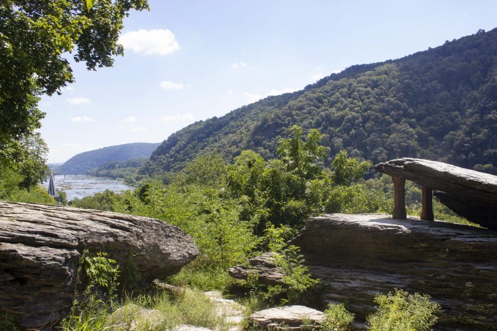 Rocky overlook with mountains and river in background