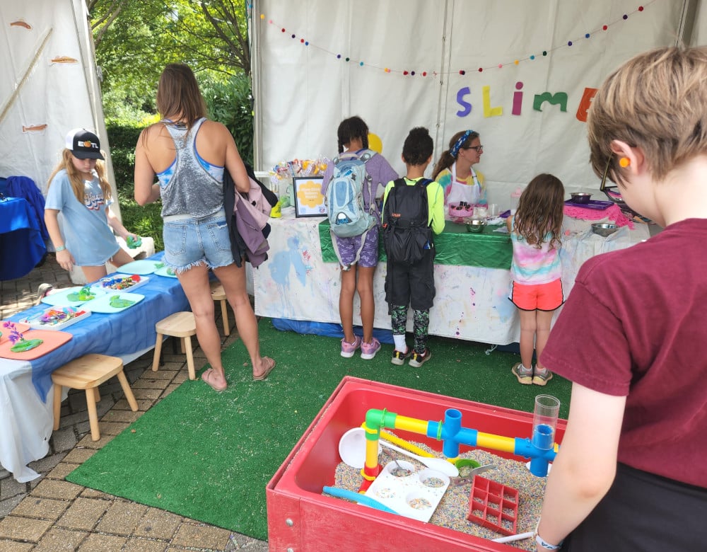 The TN Art Yard booth at the Moon River Festival attracted a steady stream of kids ready to make slime or play with the rice table.