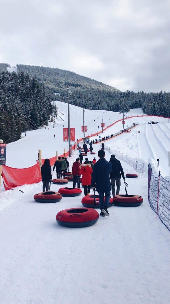 Amazing non-ski winter vacations - families waiting in line to snow tube, winter fun, tubing