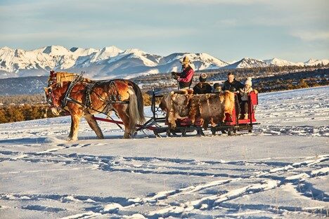 Family horse ride in the Colorado snow - Thanksgiving Getaways For Families