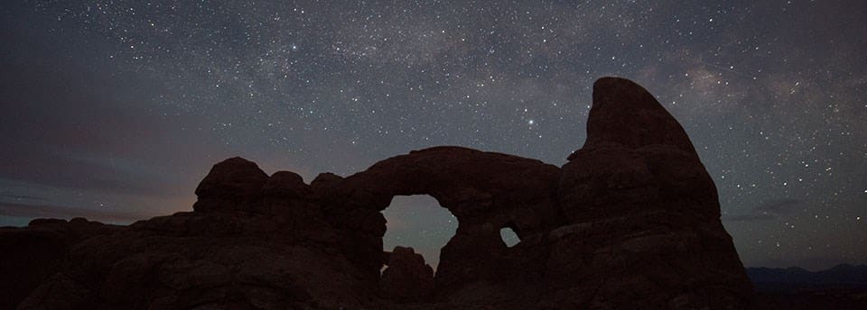Arches National park with stars in the sky - Thanksgiving Getaways For Families