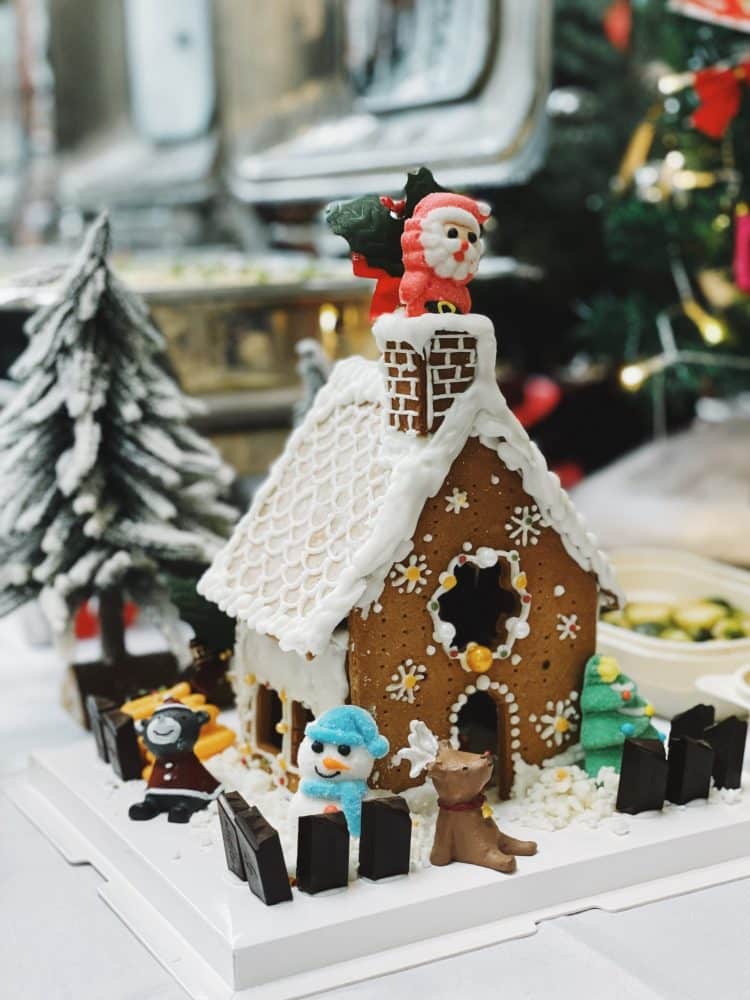 Homemade gingerbread house with holiday decorations - Christmas Family Bucket List