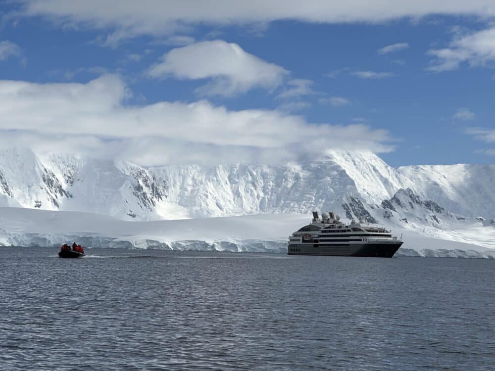 boat by iceberg - Adventures by Disney Antarctica