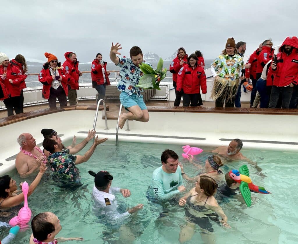 man jumping into pool - Adventures by Disney Antarctica