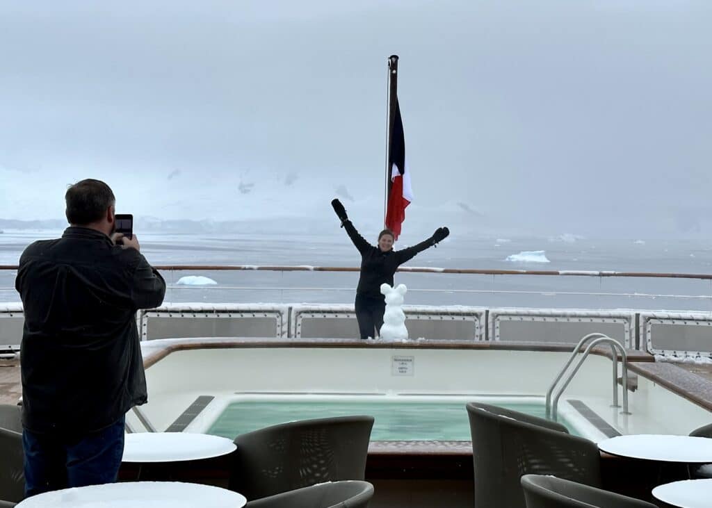 man posing on front of boat - Adventures by Disney Antarctica