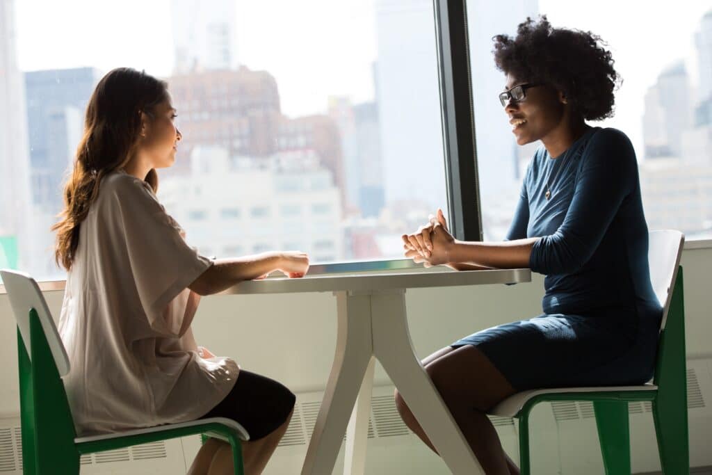 two women interviewing - the parking spot