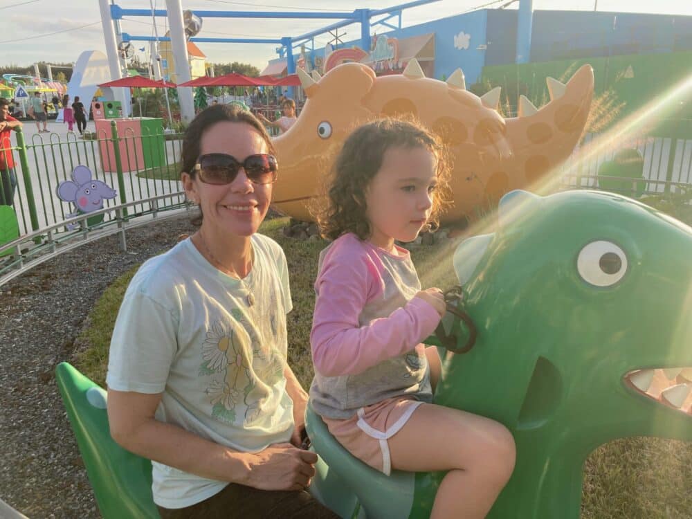 MOM and Child on Dinosaur at Peppa Pig World Theme Park Florida- Peppa Pig Theme Park Florida with family