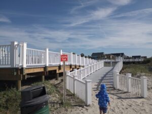 Toddler leaving Isle of Palms beach to visit the county park playground - 5 best charleston beaches for epic family vacations.