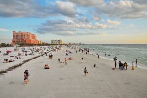 People walk on Clearwater beach - Florida family vacations, budget