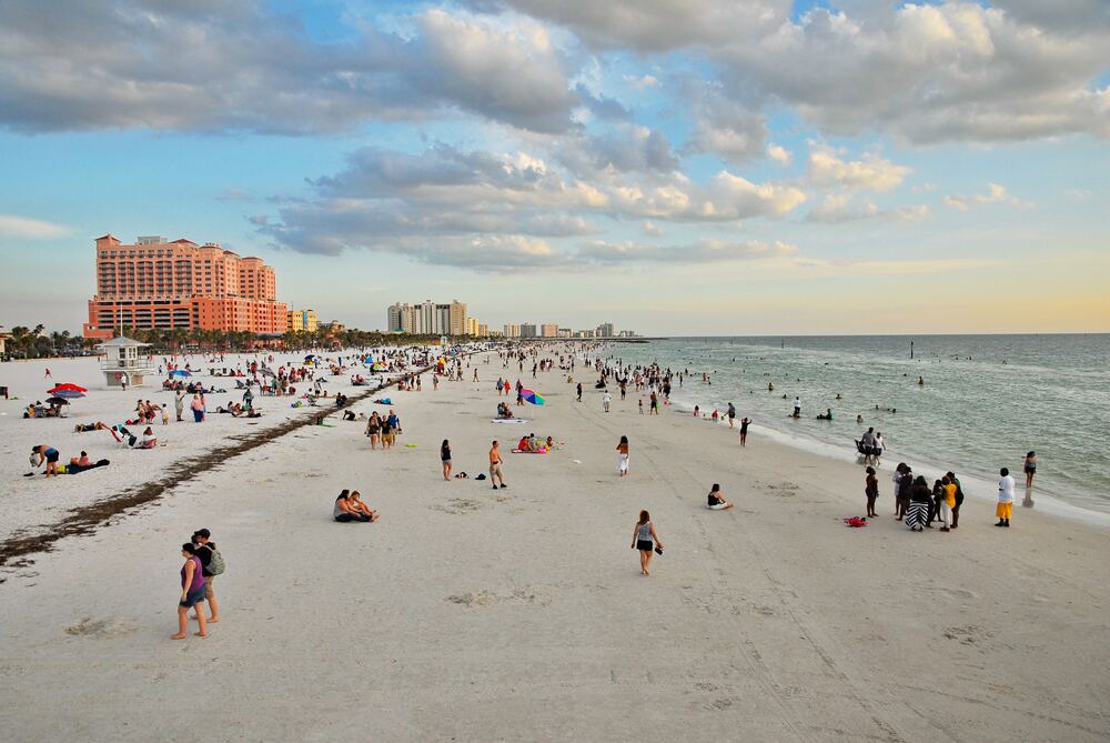 People walk on Clearwater beach - Florida family vacations, budget