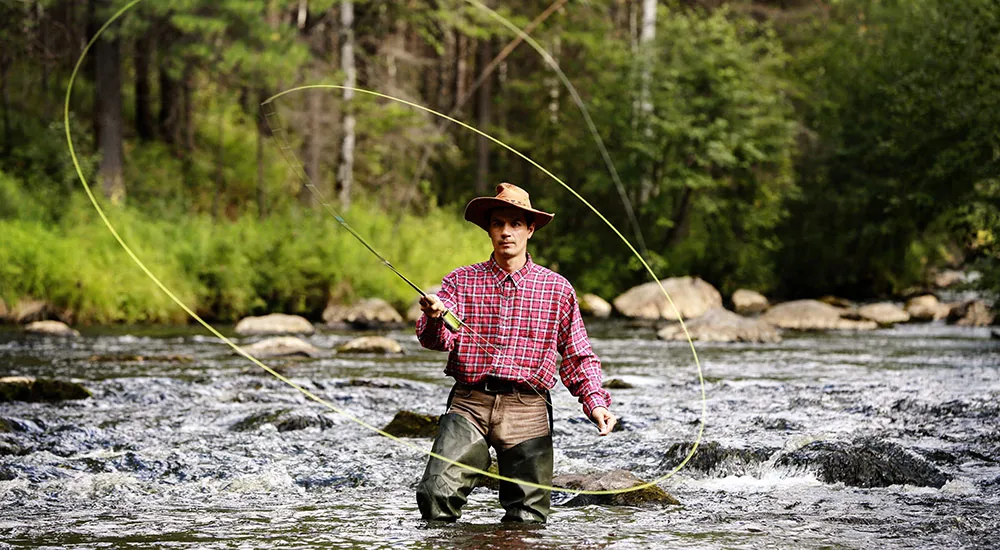 Fly fishing in waders at shore lodge Idaho