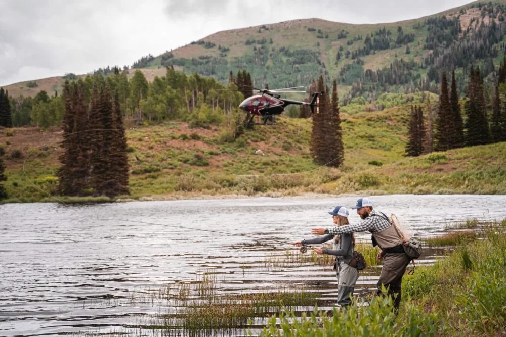 People Fishing with helicopter in the background - Fishing Trips For Kids