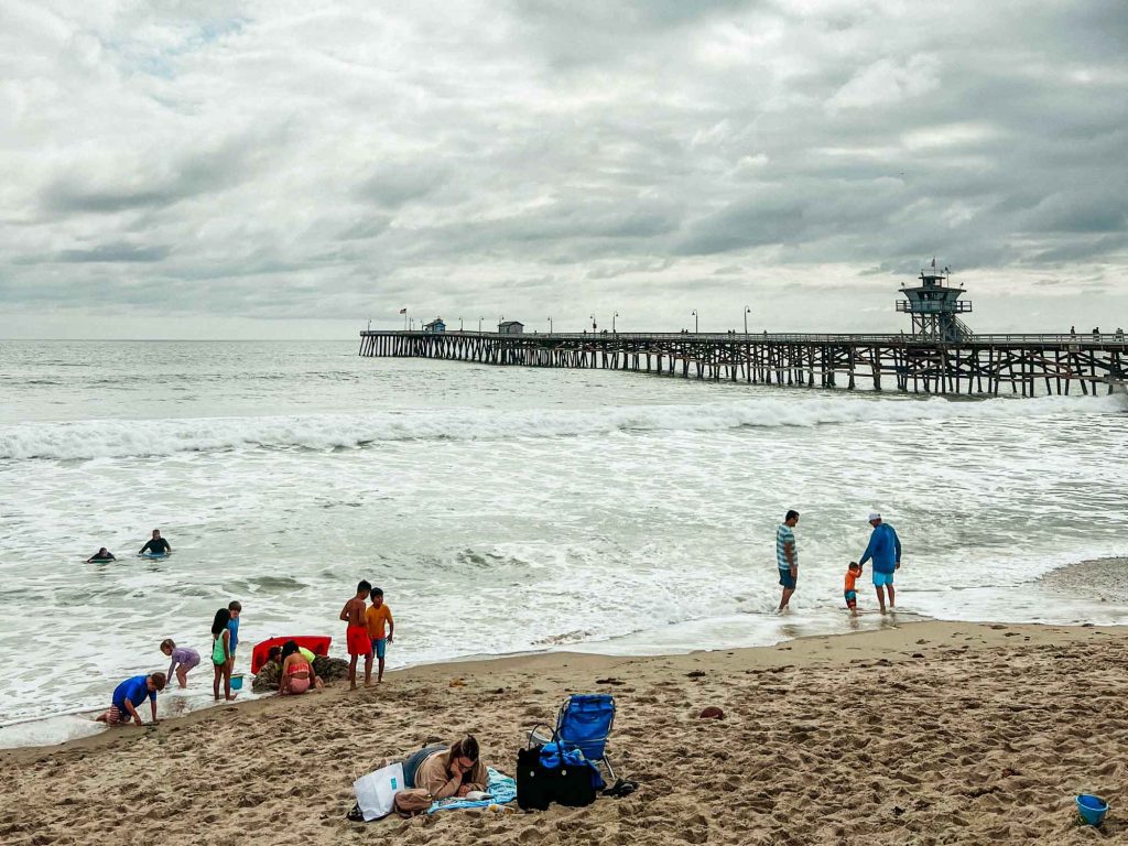 families at beach with pier - best ca beaches for families