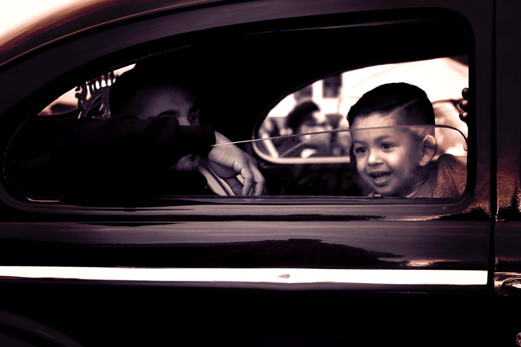 little boy looking out window of car - budget cruising