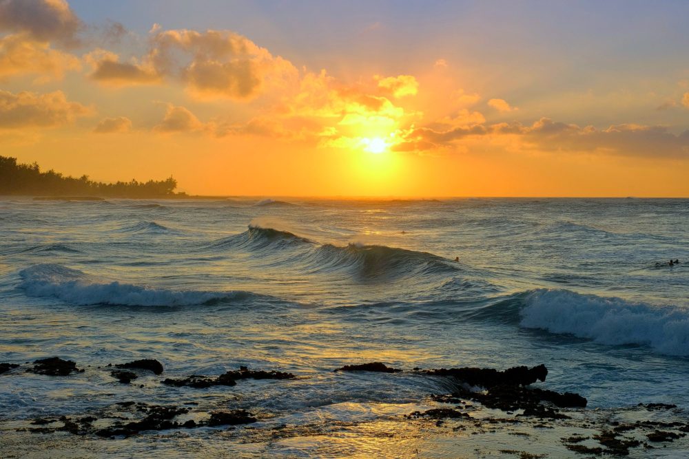 sunset over gentle waves - Best Oahu resorts for families