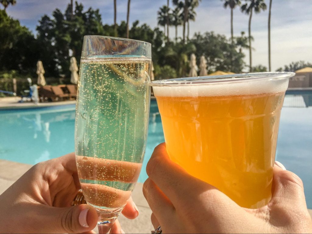 glasses with champagne and beer clinking - best hilton resorts for families