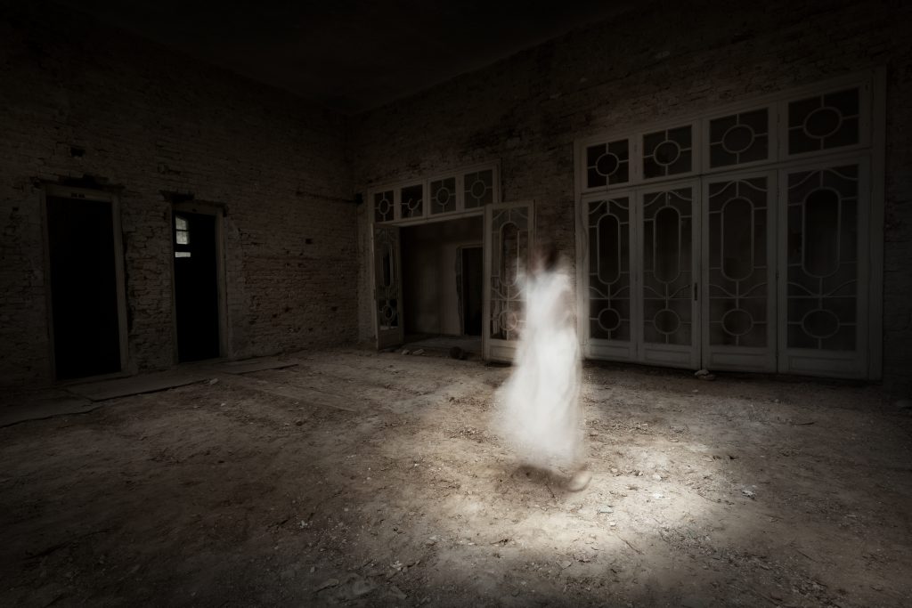 Female ghost in old ballroom - most haunted hotels in the united states