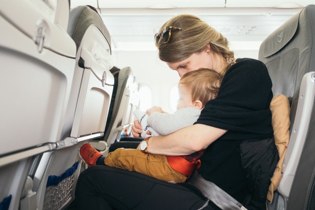 woman, baby, airplane seat, Essential Baby Packing List for Families