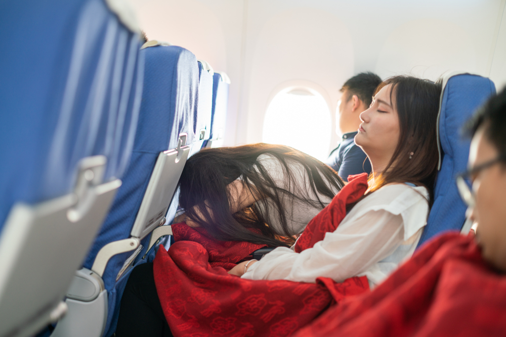 teens sleeping in plane - BEST TRAVEL PILLOWS FOR KIDS