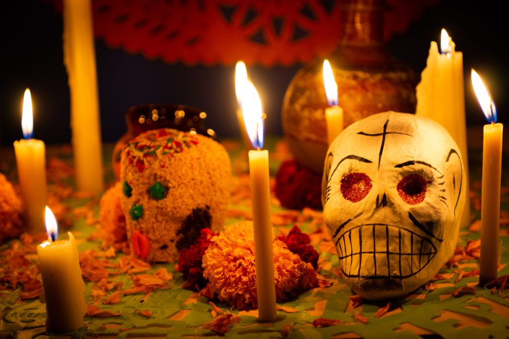 Candy skulls and candles create an altar on Day of the Dead.