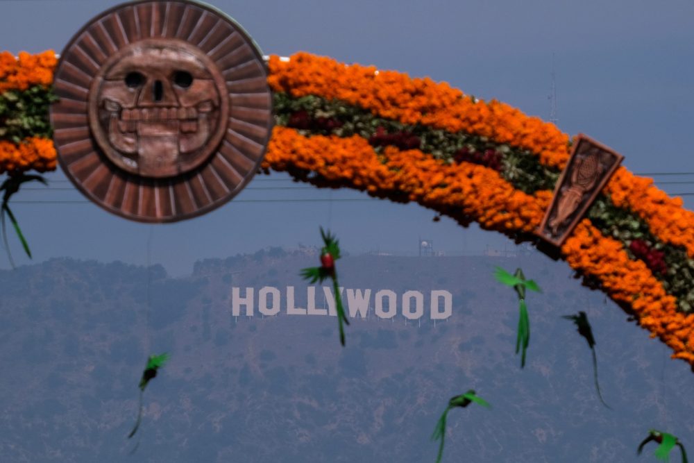 Day of the Dead Arch made of marigolds looks over the Hollywood sign