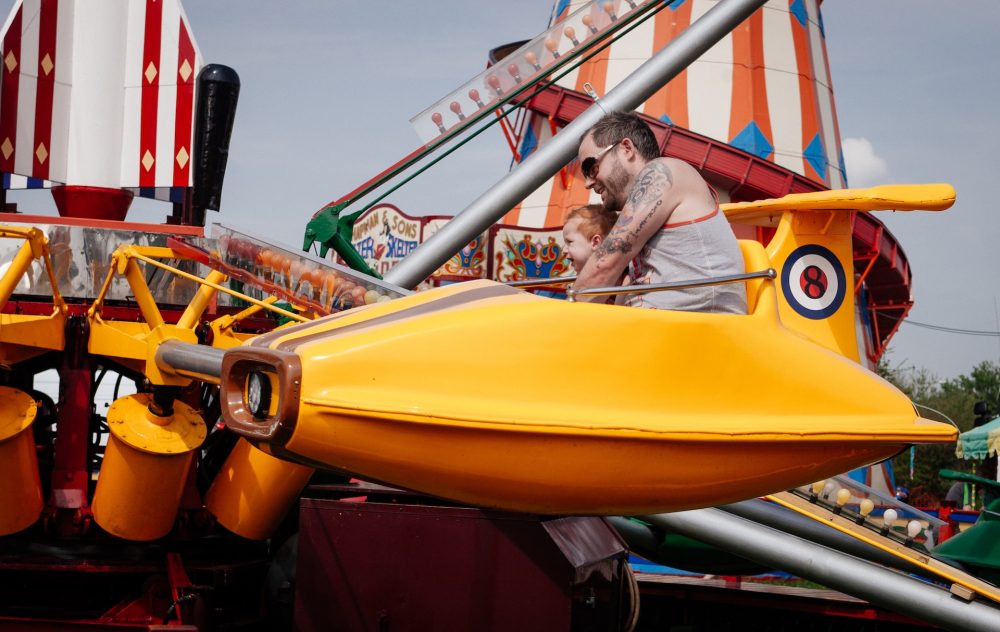 Father and son on amusement park ride - best family vacations in the United States