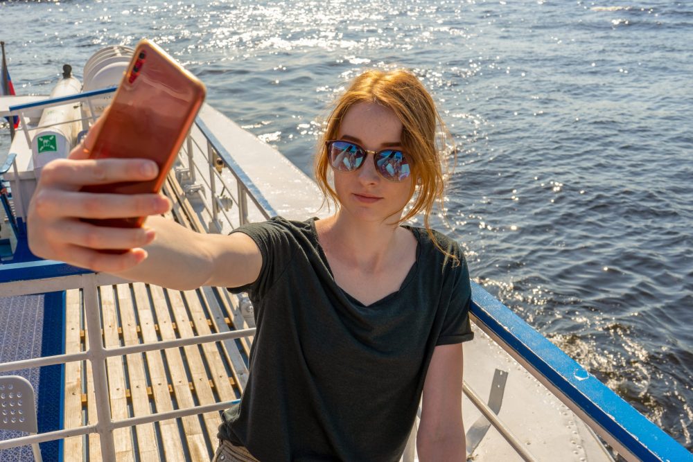 Girl taking selfie on cruise - best cruises for teens