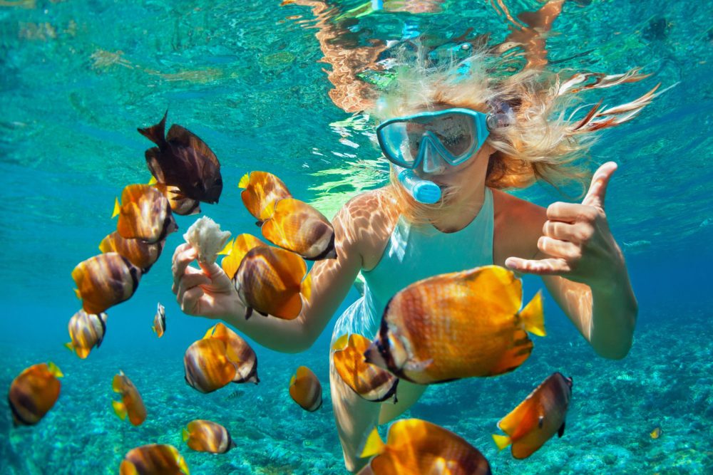 girl snorkeling in turquoise water - best cruises for teens