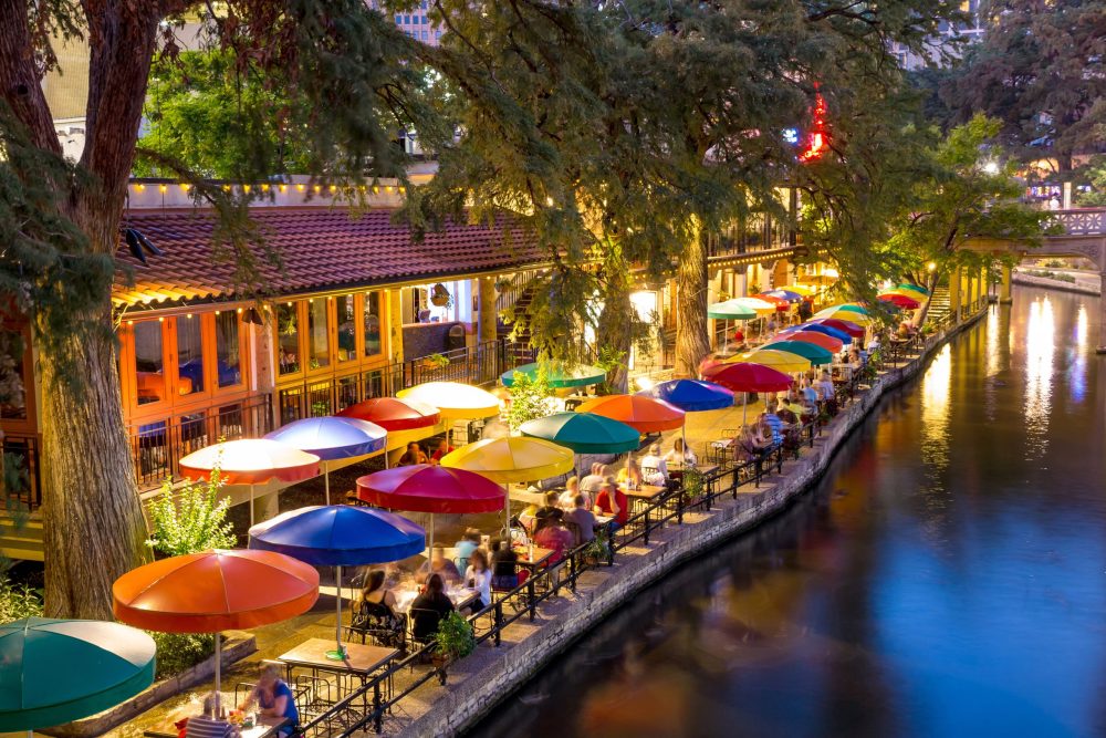 colorful umbrellas and shops along the river - Vacation Spots for Teens in the U.S.