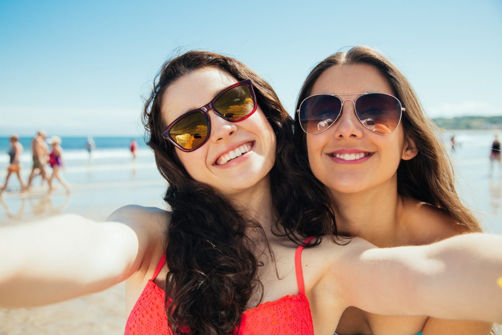 Selfie of two friends on the beach - Vacation Spots for Teens in the U.S.