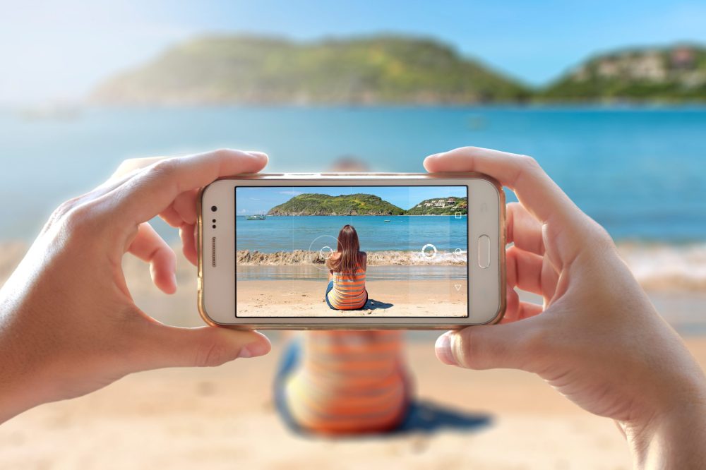 photo being taken of a girl on a beach - Vacation Spots for Teens in the U.S.