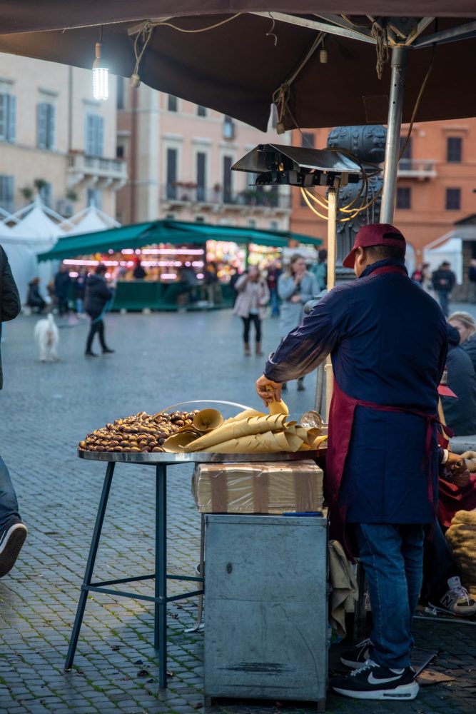 Chestnuts roasting on a street in Rome as evening falls.
