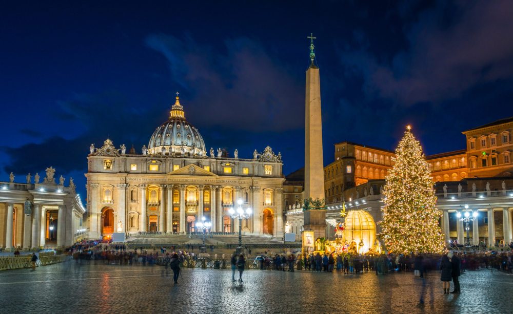 Saint Peter's Basilica at Christmas time. Christmas tree with white twinkly lights in front of the church.