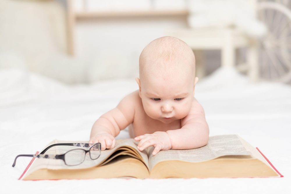 adorable baby studying a book