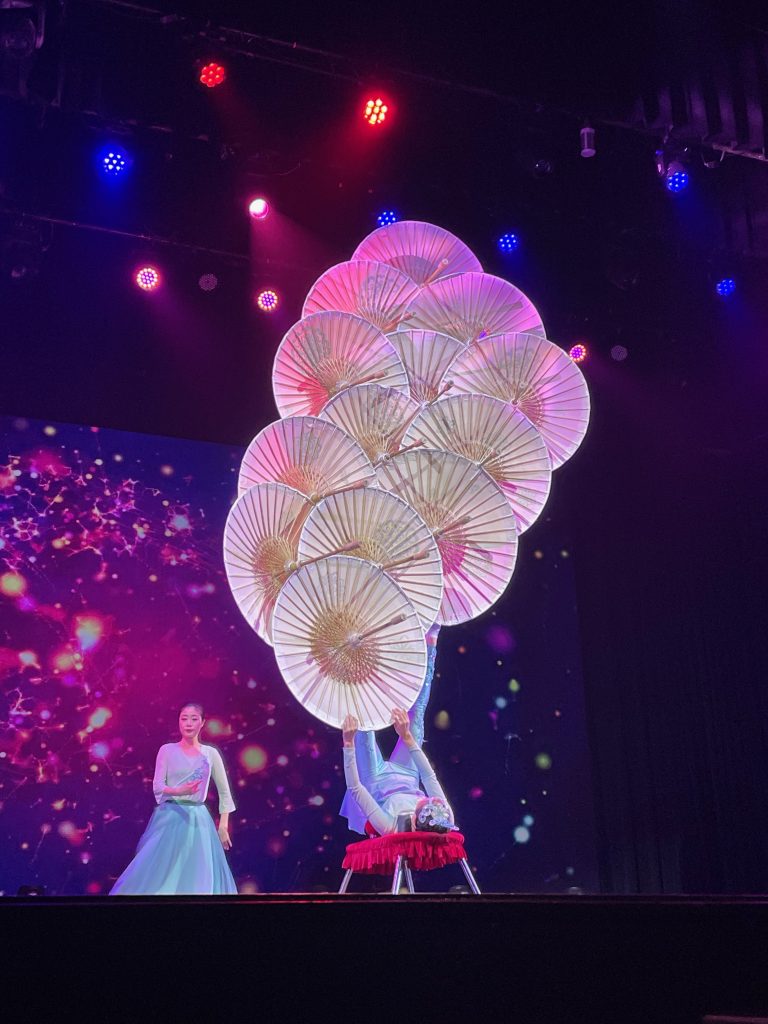 performer balancing many umbrellas with feet - branson family vacations