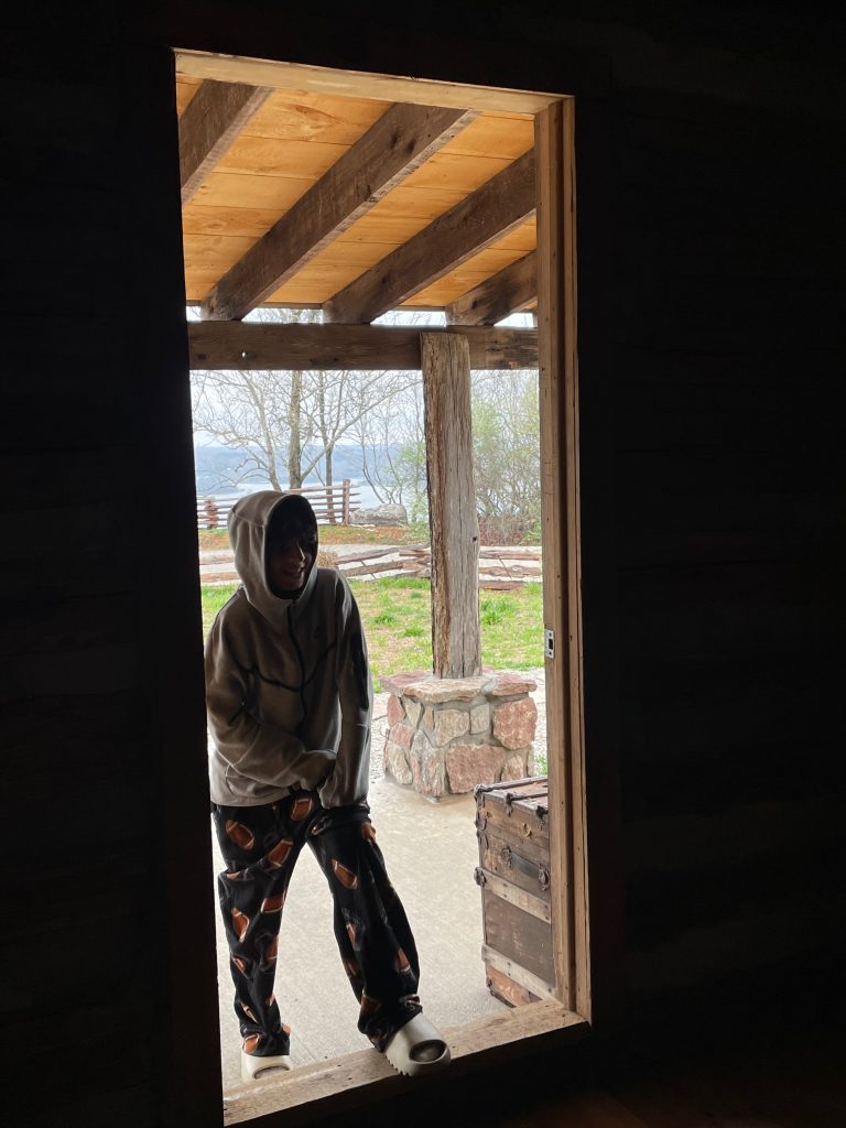 boy at cabin entrance - Branson family vacations