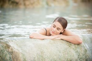 woman resting in geothermal pool -america's best luxury hot spring resorts