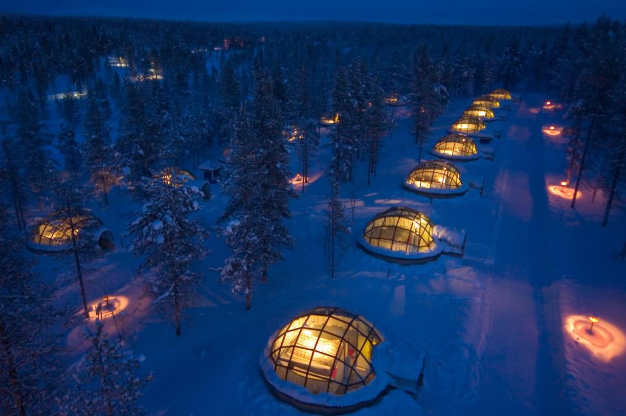 Glass covored igloos glowing with warm light during the winter months.