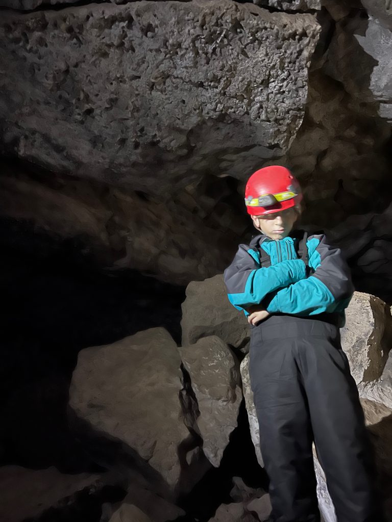 Boy in cave - family things to do in bend oregon