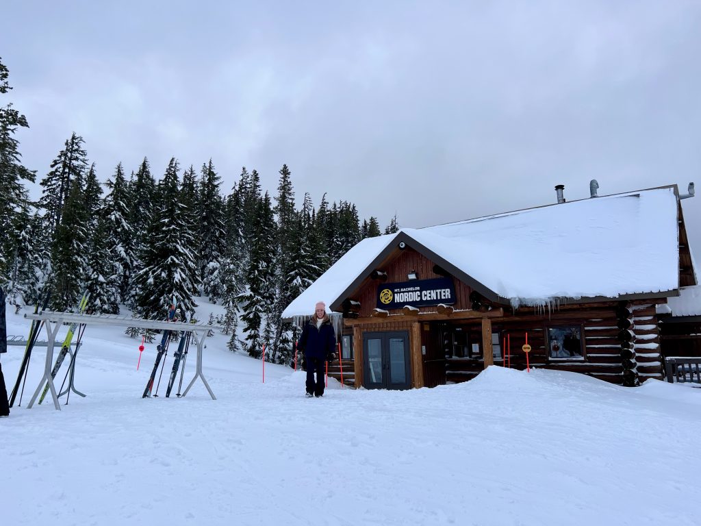 author standing in front of nordic ski center in snow - family things to do in Bend Oregon