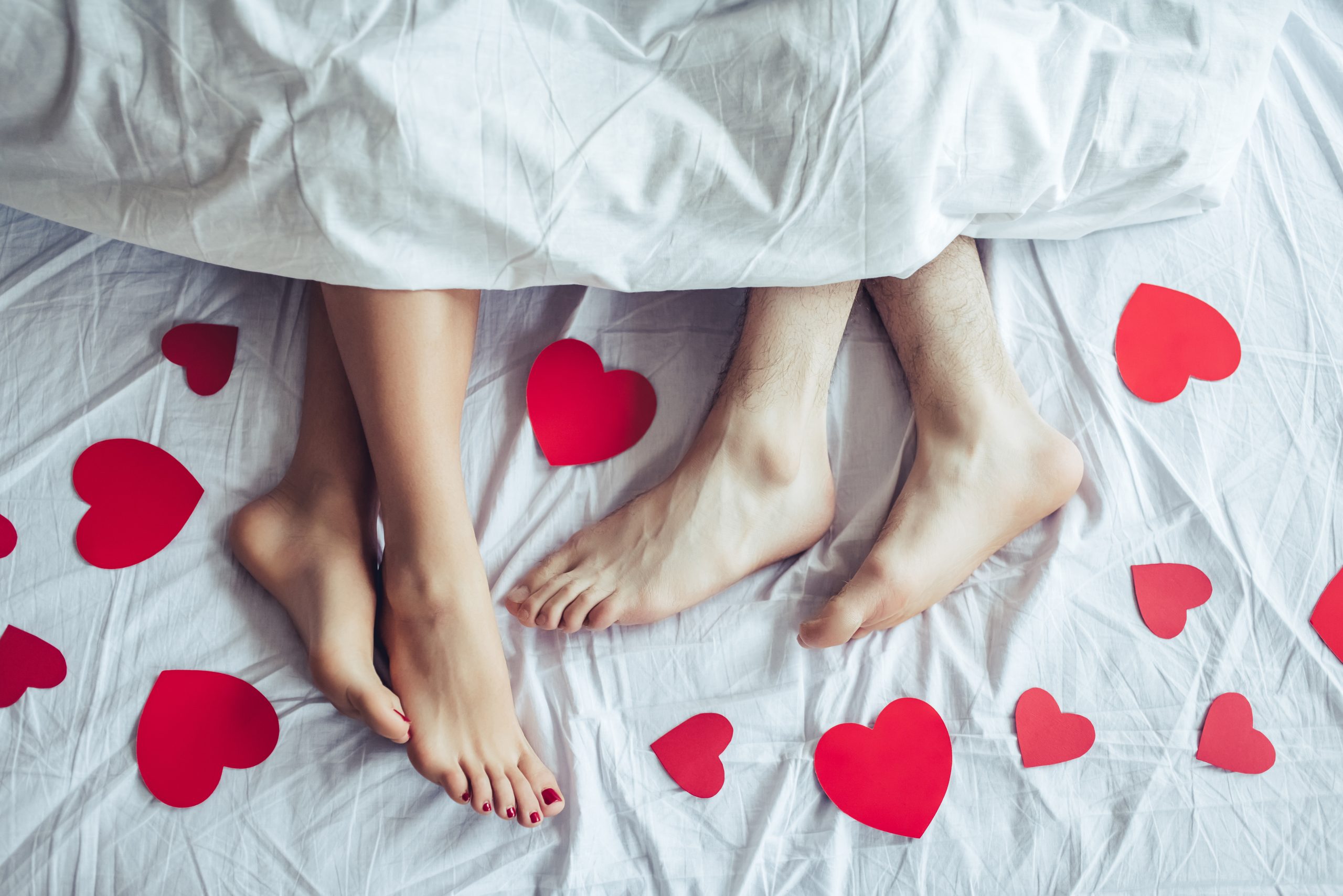 couples feet in bed with hearts -hot hotel date nights in LA