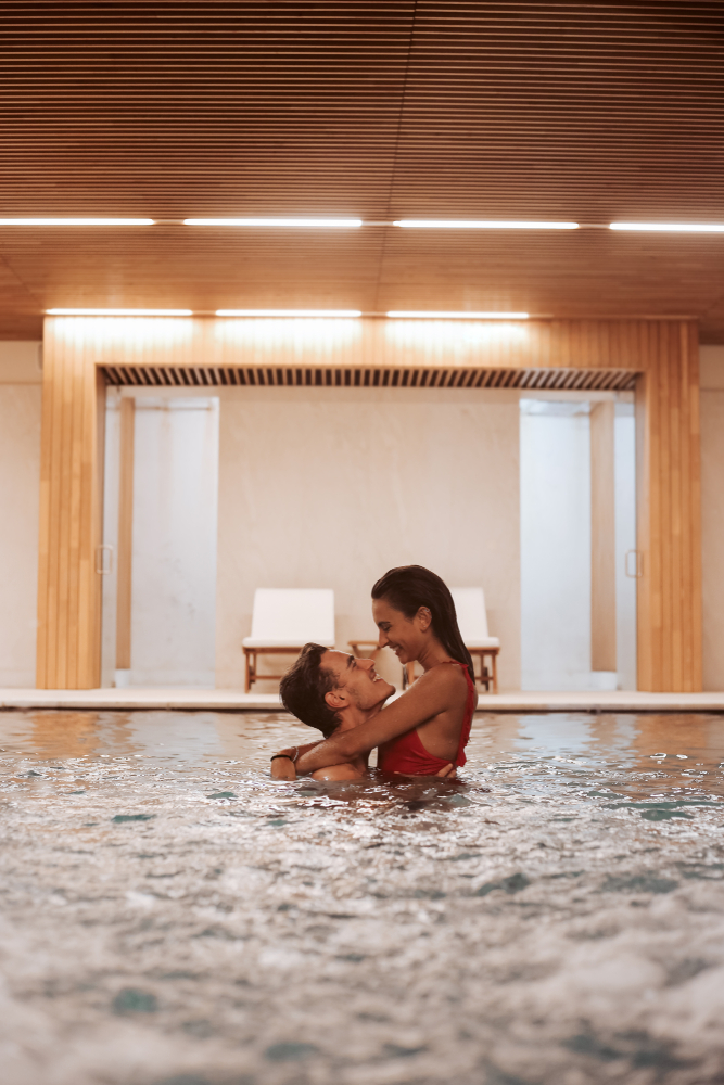 couple in hotel pool holding each other -hot hotel date night ideas in LA
