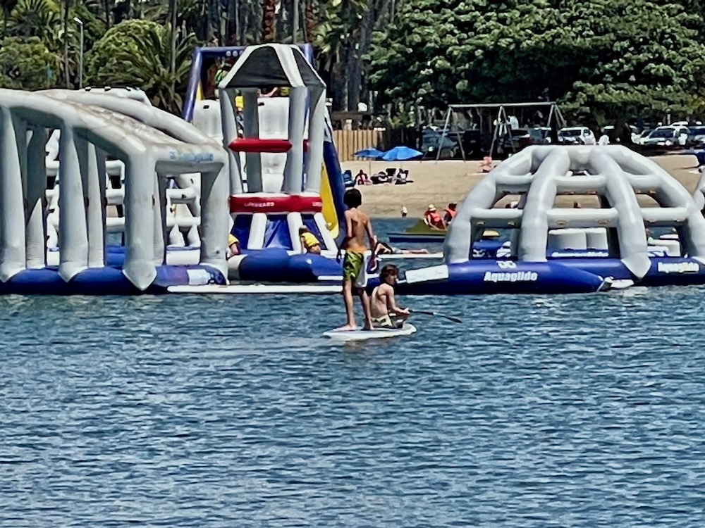 boys floating on SUP at Newport Dunes