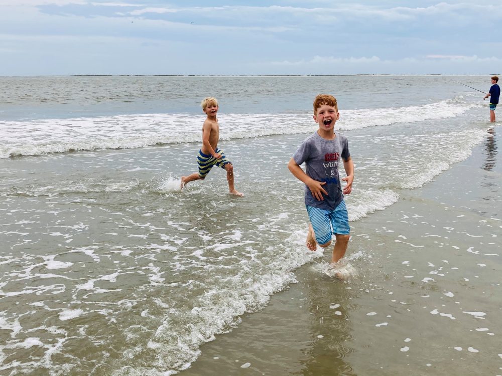 Boys laughing in the ocean's surf