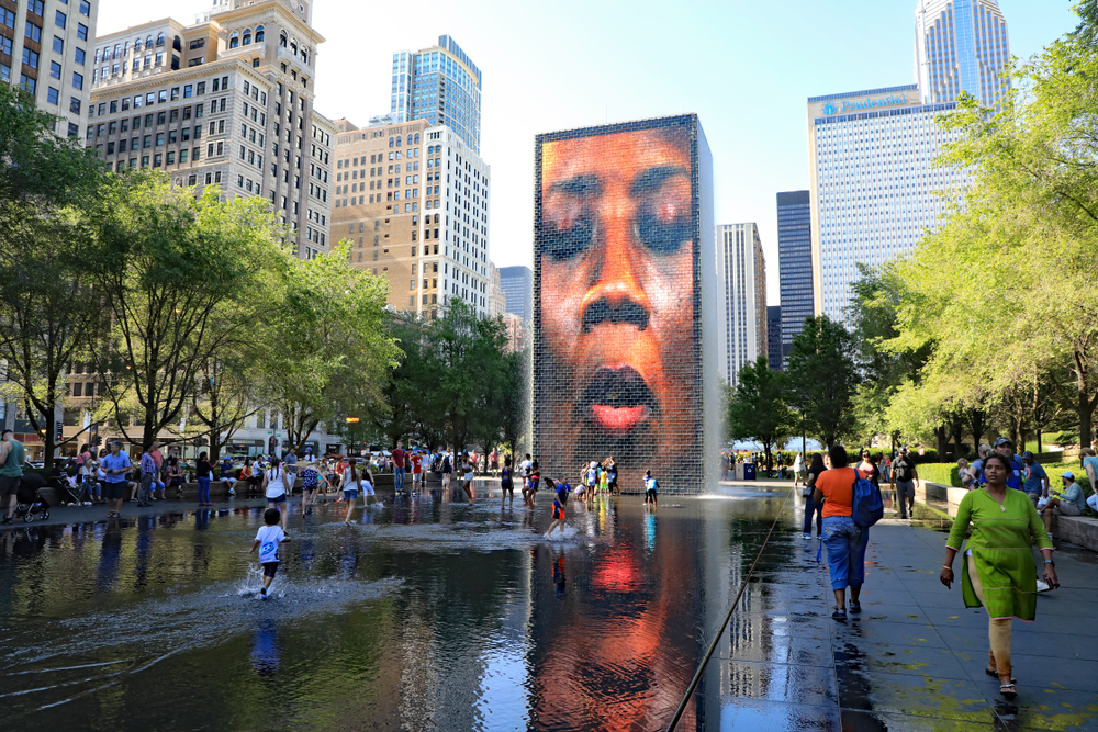 The Crown Fountain in Millennial Park is full of families enjoy the cool water. 